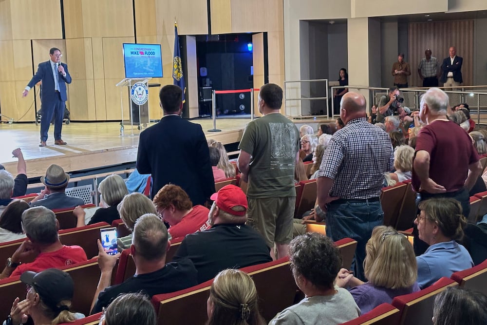Republican U.S. Rep. Mike Flood faced loud boos from a large crowd as he spoke at a town hall in Lincoln, Neb.
