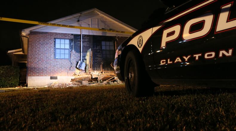 A woman was injured early Tuesday when the sport utility vehicle she was driving ran off a Clayton County road and plowed into a house.