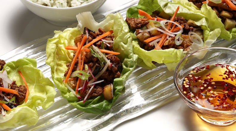 Ground pork is cooked with a sauce of rice vinegar, black bean sauce, fish sauce, sesame oil and - a departure - chipotle chiles. (E. Jason Wambsgans/Chicago Tribune/TNS)