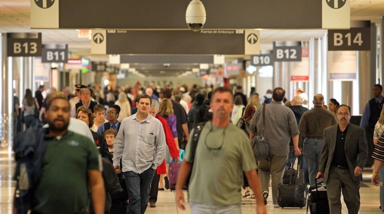 Passengers walk through Concourse B as they travel through Hartsfield-Jackson Atlanta International Airport Tuesday morning in Atlanta, Ga., April 23, 2013.