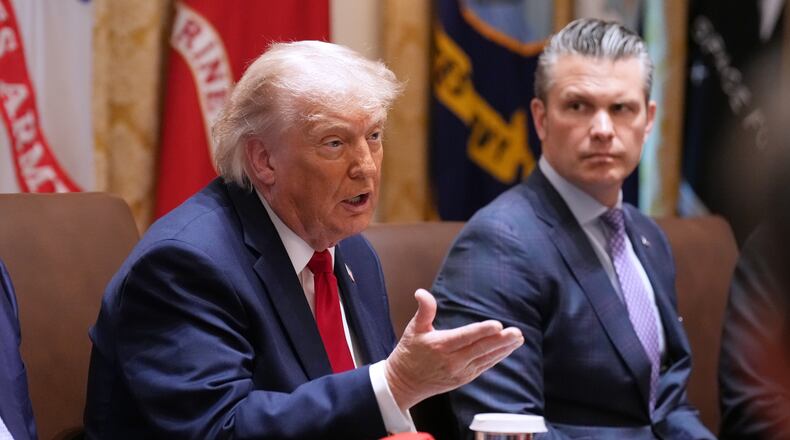 President Donald Trump speaks during a Cabinet meeting at the White House, Wednesday, May 27, 2026, in Washington, as Secretary of Defense Pete Hegseth, looks on. (AP Photo/Jacquelyn Martin)