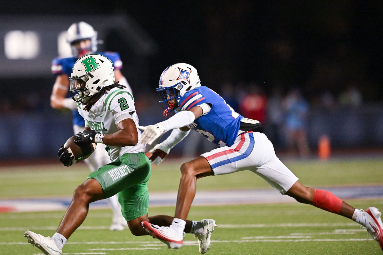 Walton cornerback Mario Dixon (12) reaches out for a tackle against Roswell’s Dre Cousey (2) as he runs the ball during the second half of a game Friday, August 29, 2025 at Walton High School. (Daniel Varnado/For the Atlanta Journal-Constitution)