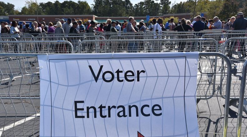 Early voters wait outside Gwinnett County Board of Voter Registration and Elections in Lawrenceville on Wednesday, Oct. 26, 2016. Georgia. HYOSUB SHIN / HSHIN@AJC.COM