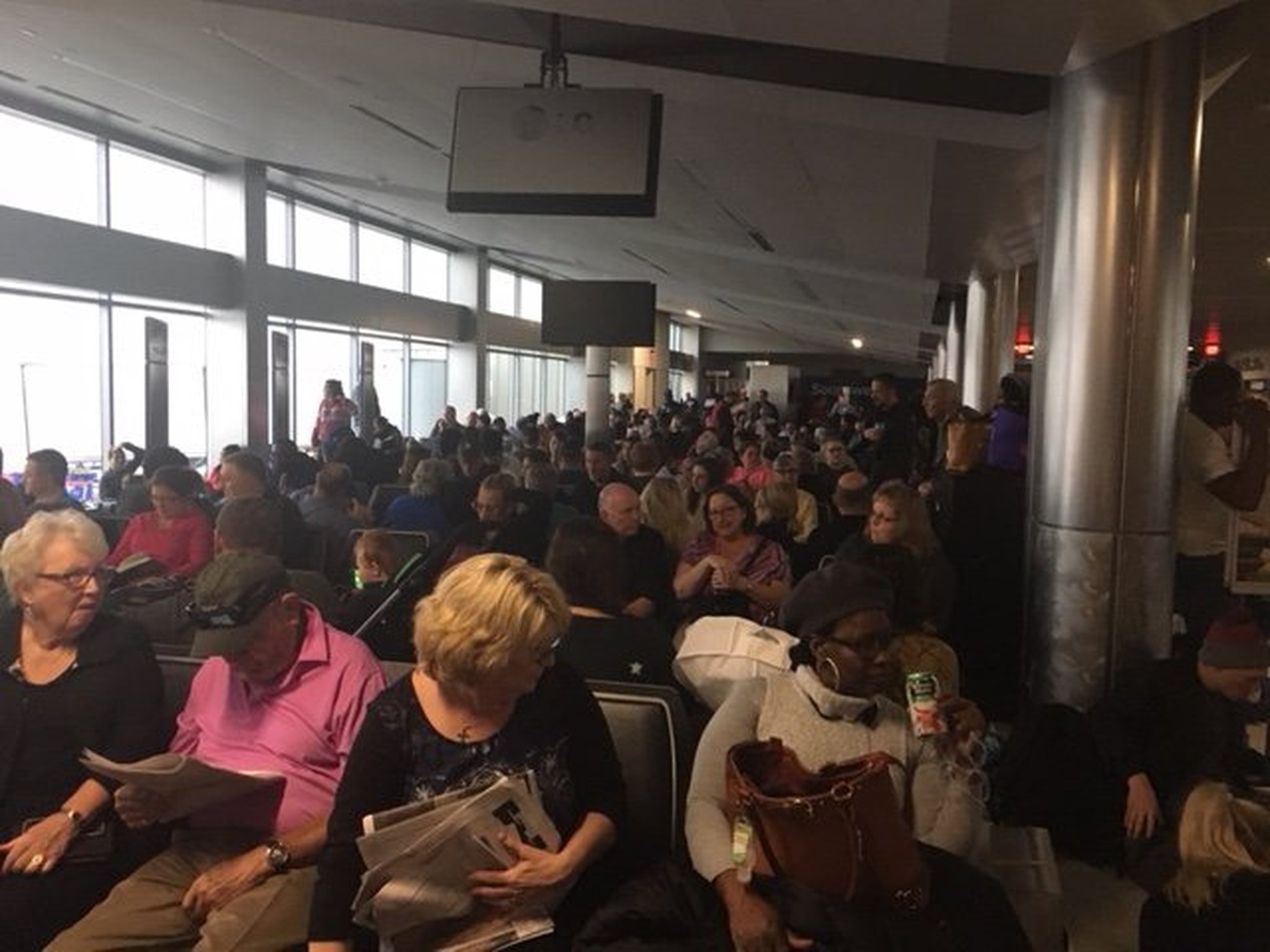 Passengers wait to exit Concourse C around 4 p.m. Sunday, Dec. 17, 2017, after power at Hartsfield-Jackson International Airport had been out for about three hours. (Photo by Rick Crotts / AJC)