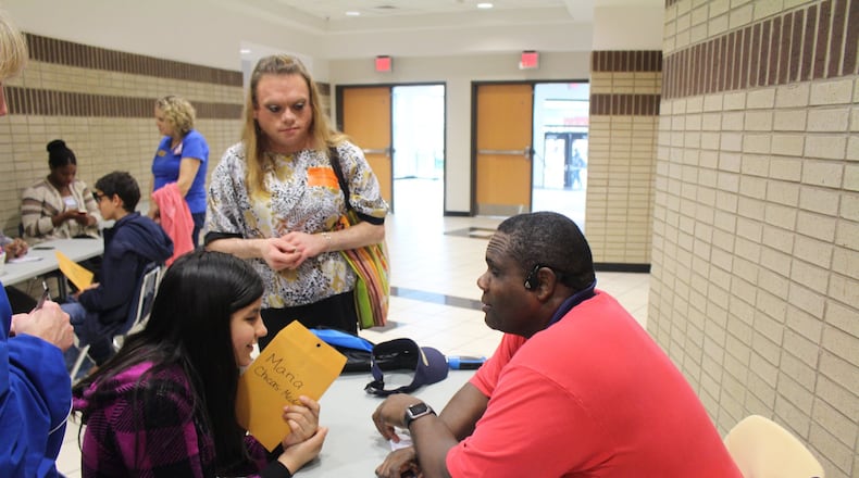 Vincent Martin, a visually-impaired graduate research assistant at Georgia Tech, speaks with Trickum Middle schooler Maria Chicas-Medrano during the district’s first career fair held at Parkview High specifically for visually-impaired students. Credit: Sue LaFave.
