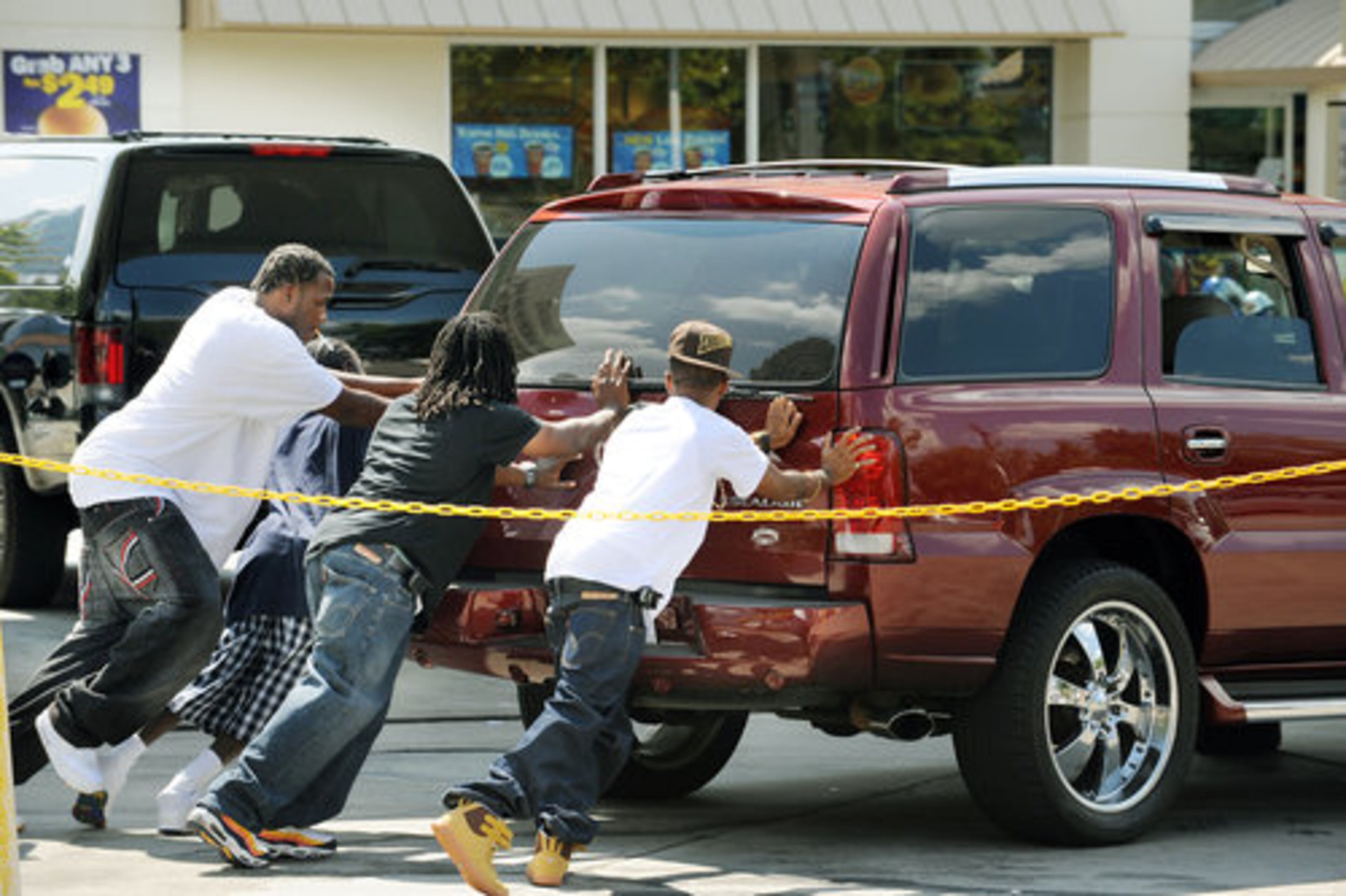 Sept. 2008 -- A Cadillac Escalade was pushed to a pump after waiting in line for gas at the BP station at North Avenue and Spring Street in Atlanta.