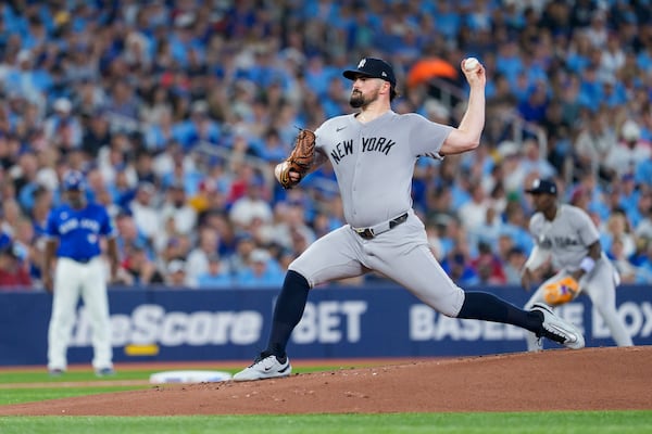 New York Yankees pitcher Carlos Rodon throws against the Toronto Blue Jays during first-inning baseball game action in Toronto, Monday, June 30, 2025. (Thomas Skrlj/The Canadian Press via AP)