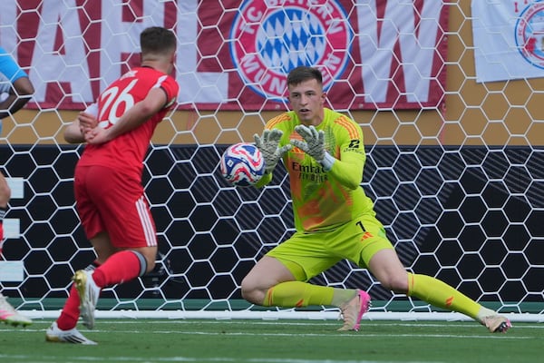 Benfica's Anatoliy Trubin blocks a shot during the Club World Cup Group C soccer match between Benfica and Bayern Munich in Charlotte, N.C., Tuesday, June 24, 2025. (AP Photo/Chris Carlson)