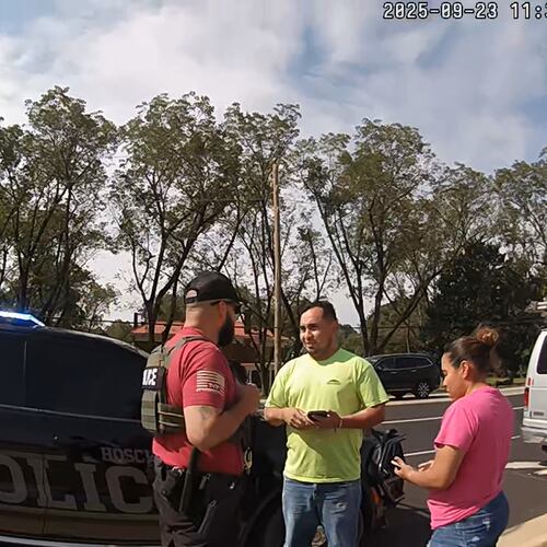The driver and passenger riding in a work van speak with a U.S. Immigration and Customs Enforcement agent immediately after being pulled over by local police on Tuesday, Sept. 23, 2025, in Hoschton. (Courtesy of the Hoschton Police Department)
