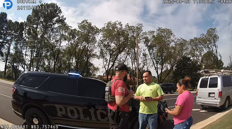 The driver and passenger riding in a work van speak with a U.S. Immigration and Customs Enforcement agent immediately after being pulled over by local police on Tuesday, Sept. 23, 2025, in Hoschton. (Courtesy of the Hoschton Police Department)