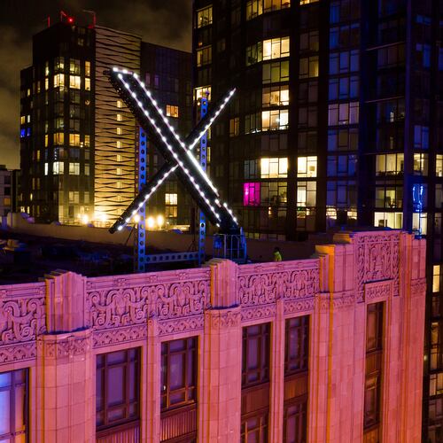 FILE - Workers install lighting on an "X" sign atop the company headquarters, formerly known as Twitter, in downtown San Francisco, July 28, 2023. (AP Photo/Noah Berger, File)