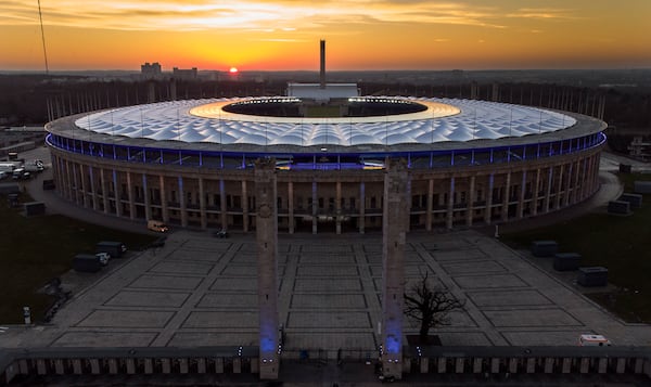 FILE - The sun sets behind the Olympic Stadium in Berlin, Germany, Sunday, Feb. 21, 2021. (AP Photo/Michael Sohn, File)