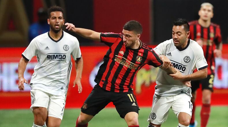 October 24, 2019 Atlanta: Atlanta United midfielder Eric Remedi is fouled battling Philadelphia defenders in the Eastern Conference semifinals of the MLS playoffs on Thursday, October 24, 2019, in Atlanta. Curtis Compton/ccompton@ajc.com