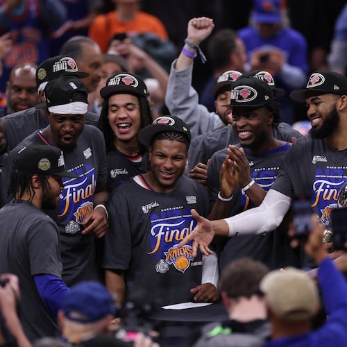 New York Knicks players celebrate with guard Jalen Brunson, left, after he was awarded with the MVP trophy after winning Game 4 in the Eastern Conference finals NBA basketball playoffs series against the Cleveland Cavaliers in Cleveland, Monday, May 25, 2026. (AP Photo/Tim Phillis)