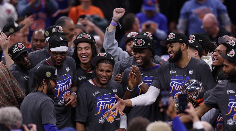 New York Knicks players celebrate with guard Jalen Brunson, left, after he was awarded with the MVP trophy after winning Game 4 in the Eastern Conference finals NBA basketball playoffs series against the Cleveland Cavaliers in Cleveland, Monday, May 25, 2026. (AP Photo/Tim Phillis)