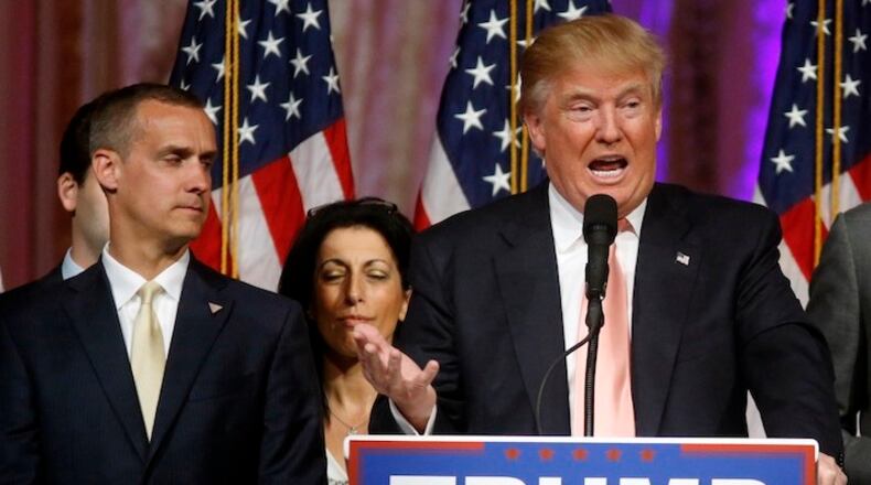 In this March 15, 2016 file photo, Donald Trump's campaign manager Corey Lewandowski listens at left are Trump speaks in Palm Beach, Fla. Trump has fought to the cusp of the Republican presidential nomination with a small group of largely obscure operatives. There's campaign manager Lewandowski, who had no national campaign experience. (AP Photo/Gerald Herbert, File)
