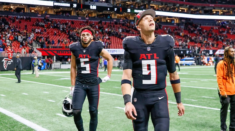 Atlanta Falcons quarterback Desmond Ridder (9) looks up as he leaves the field, followed by Atlanta Falcons wide receiver Drake London (5) after the Falcons lose against the Tampa Bay Buccaneers 29-25 at Mercedes-Benz Stadium on Sunday, Dec. 10, 2023.
Miguel Martinez/miguel.martinezjimenez@ajc.com