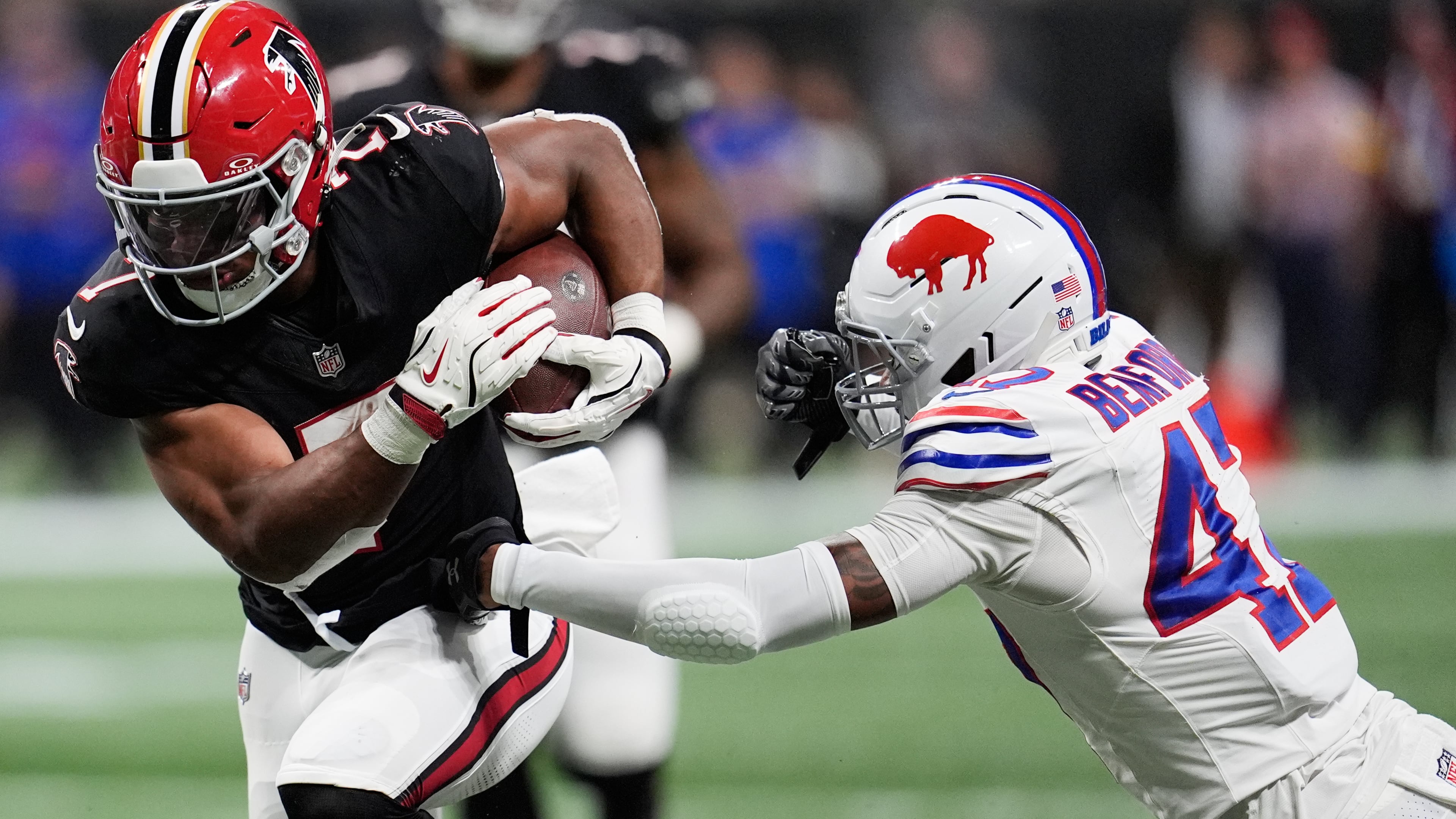 Falcons running back Bijan Robinson (left) runs past Bills cornerback Christian Benford during the first half Monday, Oct. 13, 2025, in Atlanta. Robinson had 238 total yards — 170 rushing, 68 passing — in the 24-14 win over Buffalo. (Mike Stewart/AP)