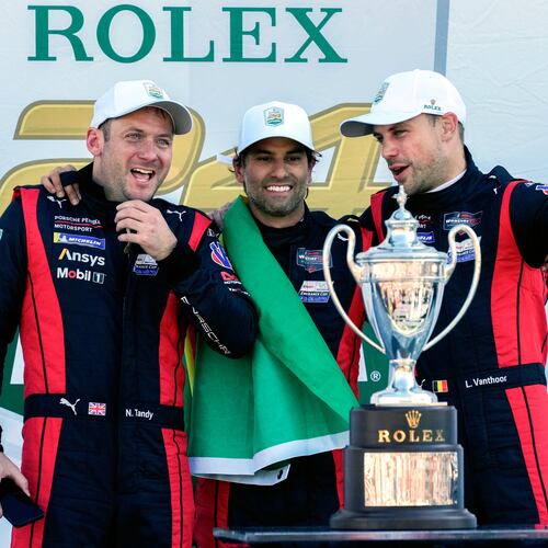 FILE - Porsche Penske Motorsport team members, from left to right, Britain's Nick Tandy, Brazil's Felipe Nasr and Belgium's Laurens Vanthoor celebrate after winning the IMSA Rolex 24 hour auto race at Daytona International Speedway, Sunday, Jan. 26, 2025, in Daytona Beach, Fla. (AP Photo/John Raoux, file)
