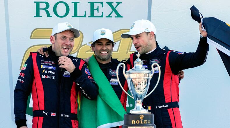 FILE - Porsche Penske Motorsport team members, from left to right, Britain's Nick Tandy, Brazil's Felipe Nasr and Belgium's Laurens Vanthoor celebrate after winning the IMSA Rolex 24 hour auto race at Daytona International Speedway, Sunday, Jan. 26, 2025, in Daytona Beach, Fla. (AP Photo/John Raoux, file)