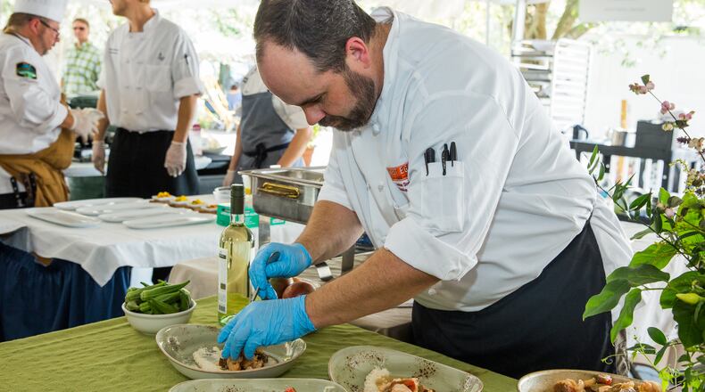 Chef Andrew Smith of West Egg prepares shrimp and grits at the Jekyll Island Shrimp and Grits Festival in 2016.