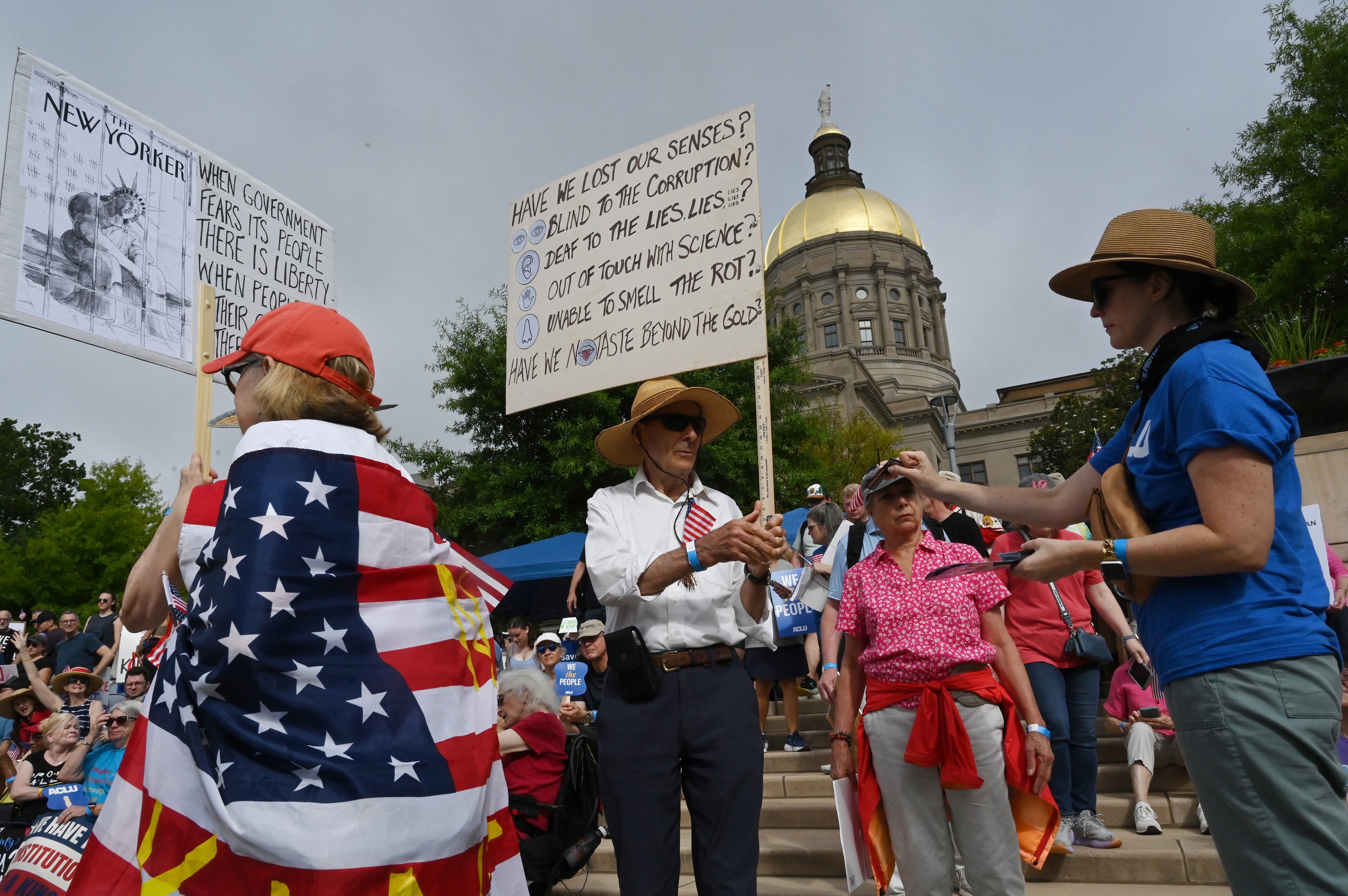 Demonstrators arrive at Liberty Plaza, near the Georgia Capitol, for a "No Kings" protest to oppose Trump’s immigration policies, Saturday, June 14, 2025, in Atlanta. (Hyosub Shin / AJC)