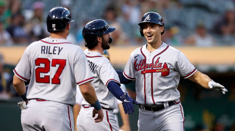 Atlanta Braves' Matt Olson, right, is congratulated by Dansby Swanson, center, and Austin Riley (27) after hitting a three-run home run against the Oakland Athletics during the third inning of a baseball game in Oakland, Calif., Tuesday, Sept. 6, 2022. (AP Photo/Jed Jacobsohn)