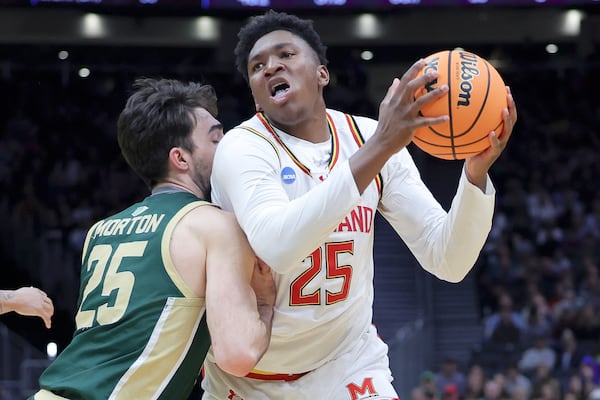 FILE - Maryland center Derik Queen, right, drives against Colorado State guard Ethan Morton during the first half in the second round of the NCAA college basketball tournament, Sunday, March 23, 2025, in Seattle. (AP Photo/Ryan Sun, File)