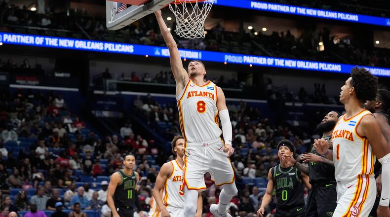 Atlanta Hawks center Kristaps Porzingis (8) goes to the basket against the New Orleans Pelicans in the second half of an NBA basketball game, Saturday, Nov. 22, 2025, in New Orleans. (AP Photo/Gerald Herbert)