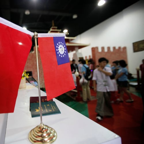 FILE - Flags of China and Myanmar are displayed at the entrance of Myanmar Pavilion prior to Myanmar's top junta leader Gen. Than Shwe to arrive at the Shanghai Expo site in Shanghai Friday, Sept.10, 2010. (AP Photo/Eugene Hoshiko, file)