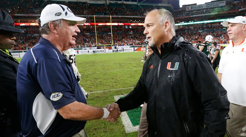 Miami head coach Mark Richt, right, and Georgia Tech head coach Paul Johnson congratulate each other after an NCAA College football game, Saturday, Oct. 14, 2017 in Miami Gardens, Fla. Miami defeated Georgia Tech 25-24. (AP Photo/Wilfredo Lee)