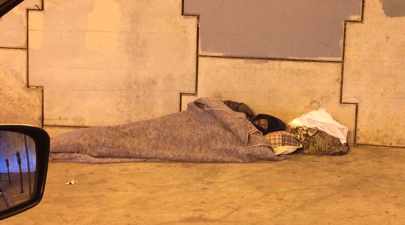 A man sleeps under the bridge near Grady Memorial Hospital in Atlanta.
