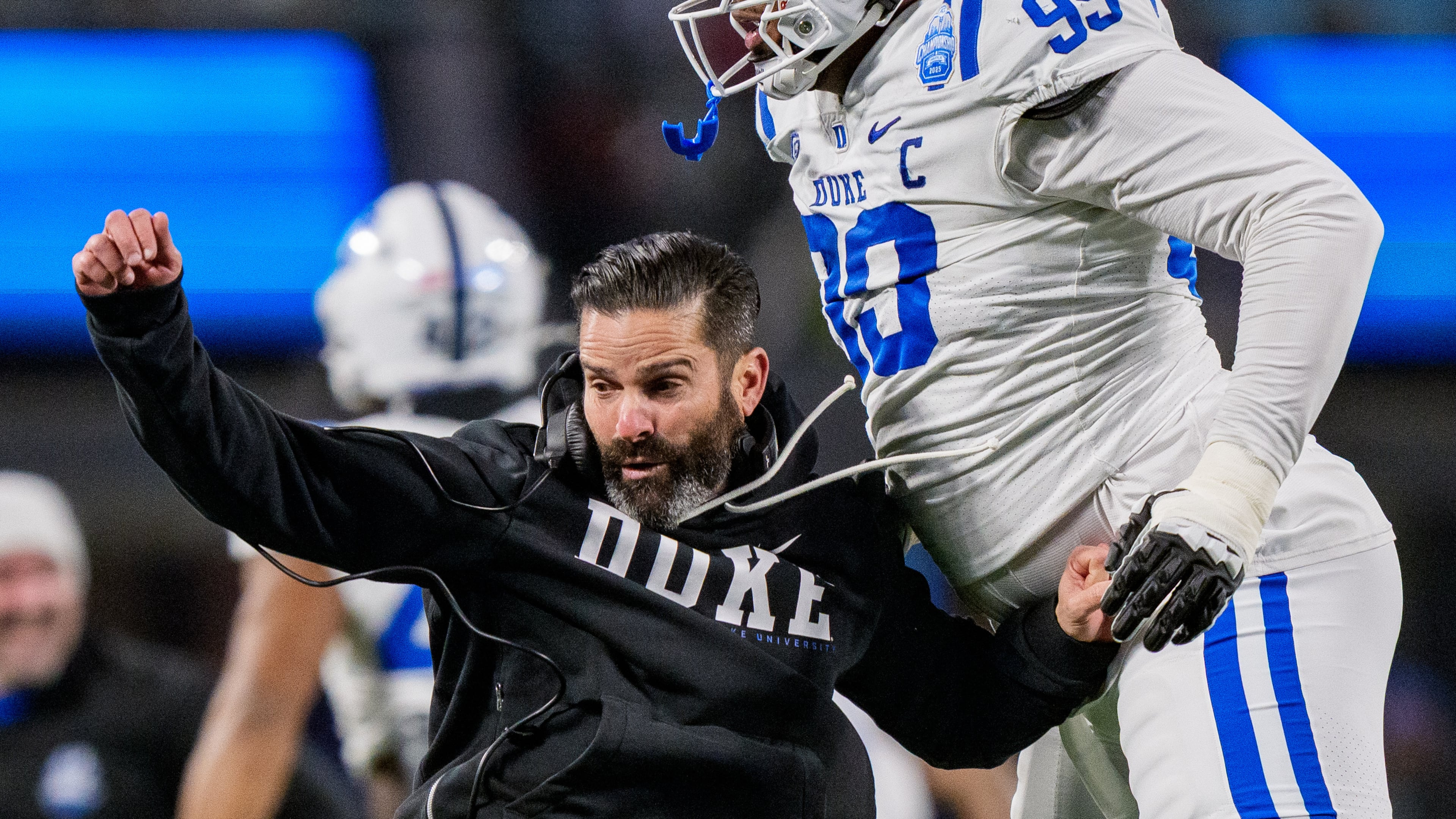 Duke head coach Manny Diaz, left, celebrates with defensive tackle Aaron Hall (99) after Virginia missed a field goal in the first half of the Atlantic Coast Conference championship NCAA college football game Saturday, Dec. 6, 2025, in Charlotte, N.C. (AP Photo/Jacob Kupferman)