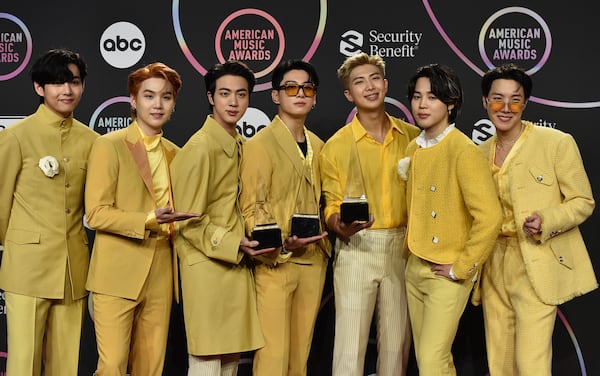 FILE - BTS poses in the press room with the awards for favorite pop duo or group, favorite pop song for "Butter," and artist of the year at the American Music Awards on Sunday, Nov. 21, 2021, at Microsoft Theater in Los Angeles. (Photo by Jordan Strauss/Invision/AP, File)