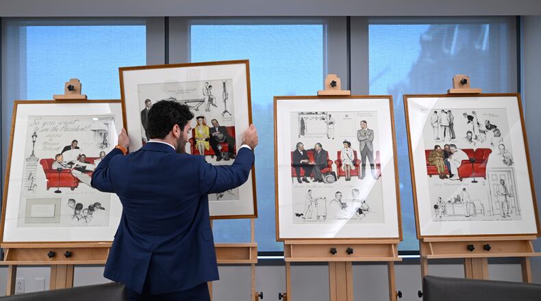 Luke Boorady, of the White House Historical Association, arranges a suite of four interrelated paintings by Norman Rockwell titled, "So You Want to See the President!" at the association's offices Wednesday, June 10, 2026, in Washington. (AP Photo/John McDonnell)