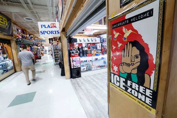 A sign inside Plaza Fiesta welcomes all immigrants. However, some shop owners are noticing a drop in their sales, which they believe is due to policies from the Trump administration that have caused worry among immigrant communities.
(Miguel Martinez/ AJC)