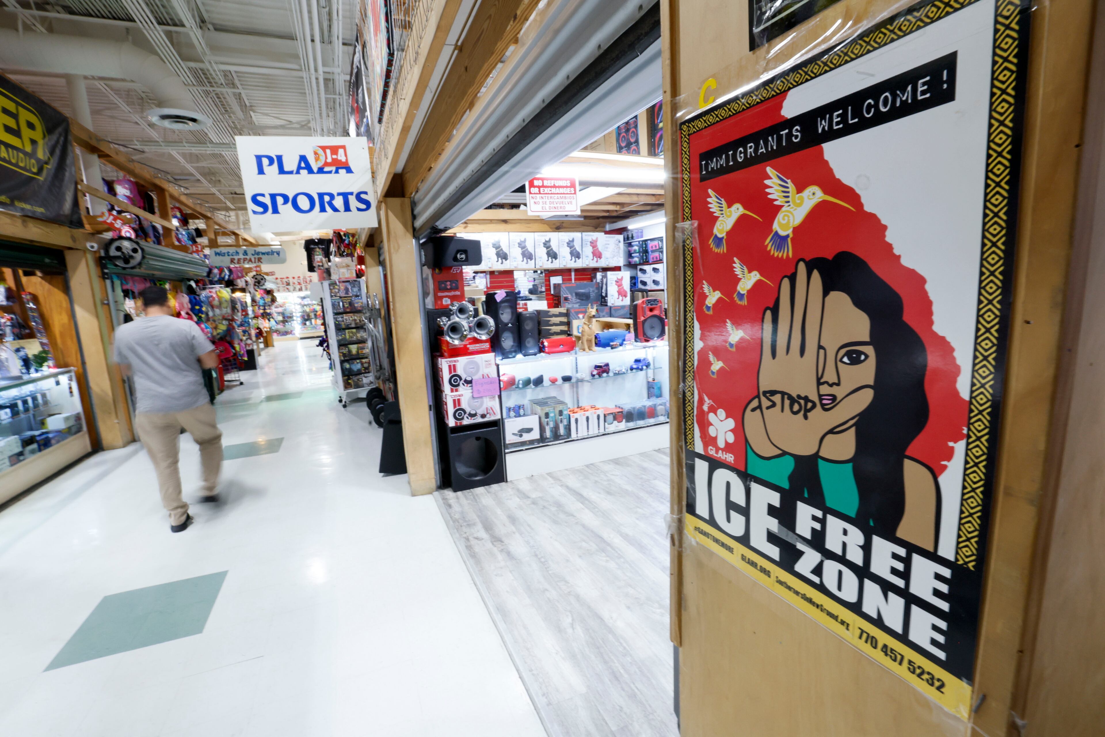 A sign inside Plaza Fiesta on Wednesday, May 7, 2025, welcomes all immigrants. However, some shop owners are noticing a drop in their sales, which they believe is due to policies from the Trump administration that have caused worry among immigrant communities. (Miguel Martinez/AJC)