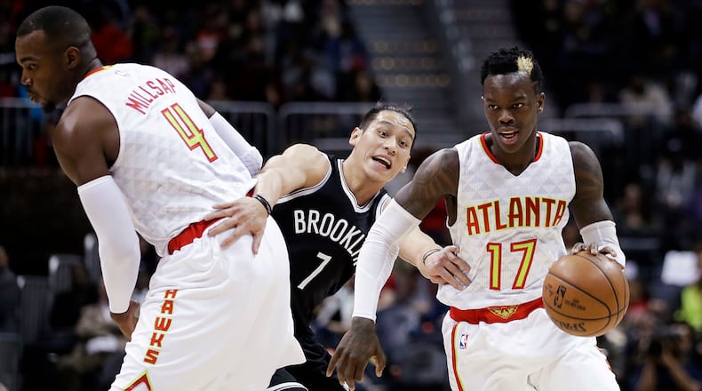 Brooklyn Nets’ Jeremy Lin, center, tries to work through a pick set by Atlanta Hawks’ Paul Millsap, left, as Dennis Schroeder, right, dribbles past during the third quarter of an NBA basketball game in Atlanta, Wednesday, March 8, 2017. Atlanta won 110-105. (AP Photo/David Goldman)