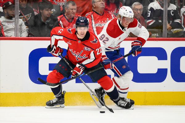 Montreal Canadiens right wing Patrik Laine (92) battles for the puck against Washington Capitals right wing Brandon Duhaime (22) in the second period of Game 1 of a first-round NHL hockey playoff series Monday, April 21, 2025, in Washington. (AP Photo/Nick Wass)