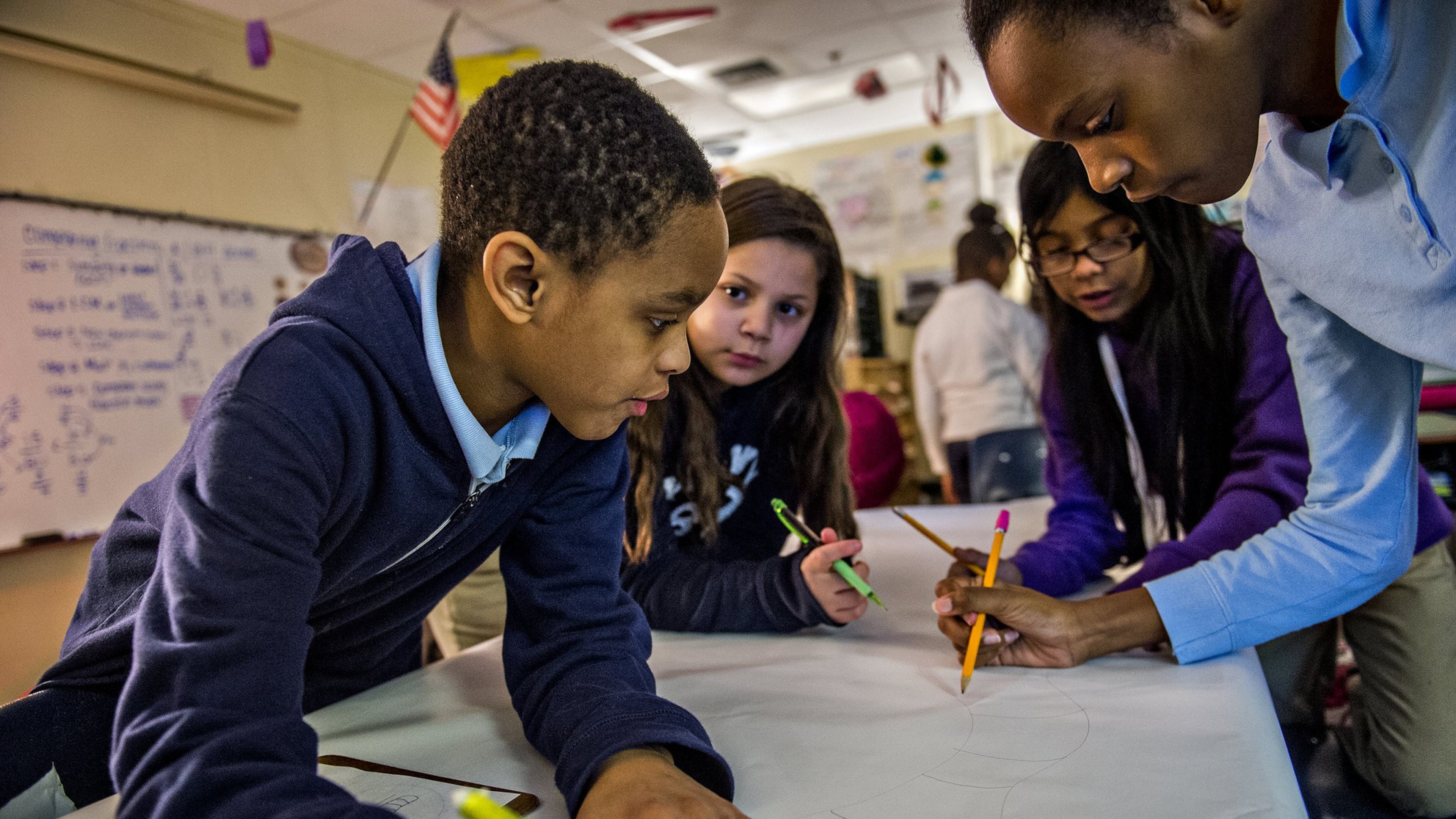 January 28, 2016 Powder Springs - Antar Green (left), Brianna Espinoza, Kathleen Alfaro and Nia Murchison work together to draw a bug character during class at Powder Springs Elementary School in Powder Springs.
