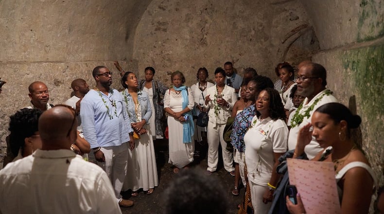 Debra Santos (blue scarf), an Atlanta Airbnb host, who is visiting Ghana as part of that nation’s “Year of the Return.” African Americans have been encouraged to return to Africa this year to mark 400 years of slavery. “My face says it all,” Santos said of the photograph, taken in an Elmina Castle dungeon where dozens of female captives would have been held before departing into slavery.