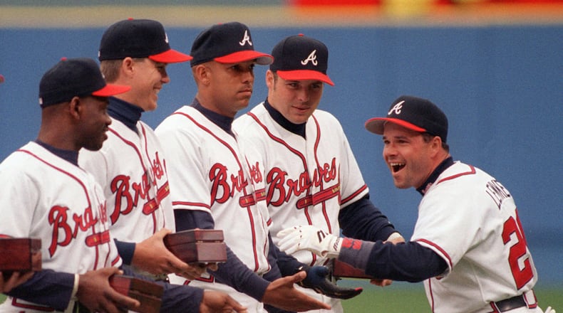 Mark Lemke celebrates with teammates upon receiving his 1995 World Series ring in April 1996. From left, Marquis Grissom, Chipper Jones, David Justice and Ryan Klesko. It came after heartbreaking Series losses in 1991-92. (Frank Niemeir / AJC staff)