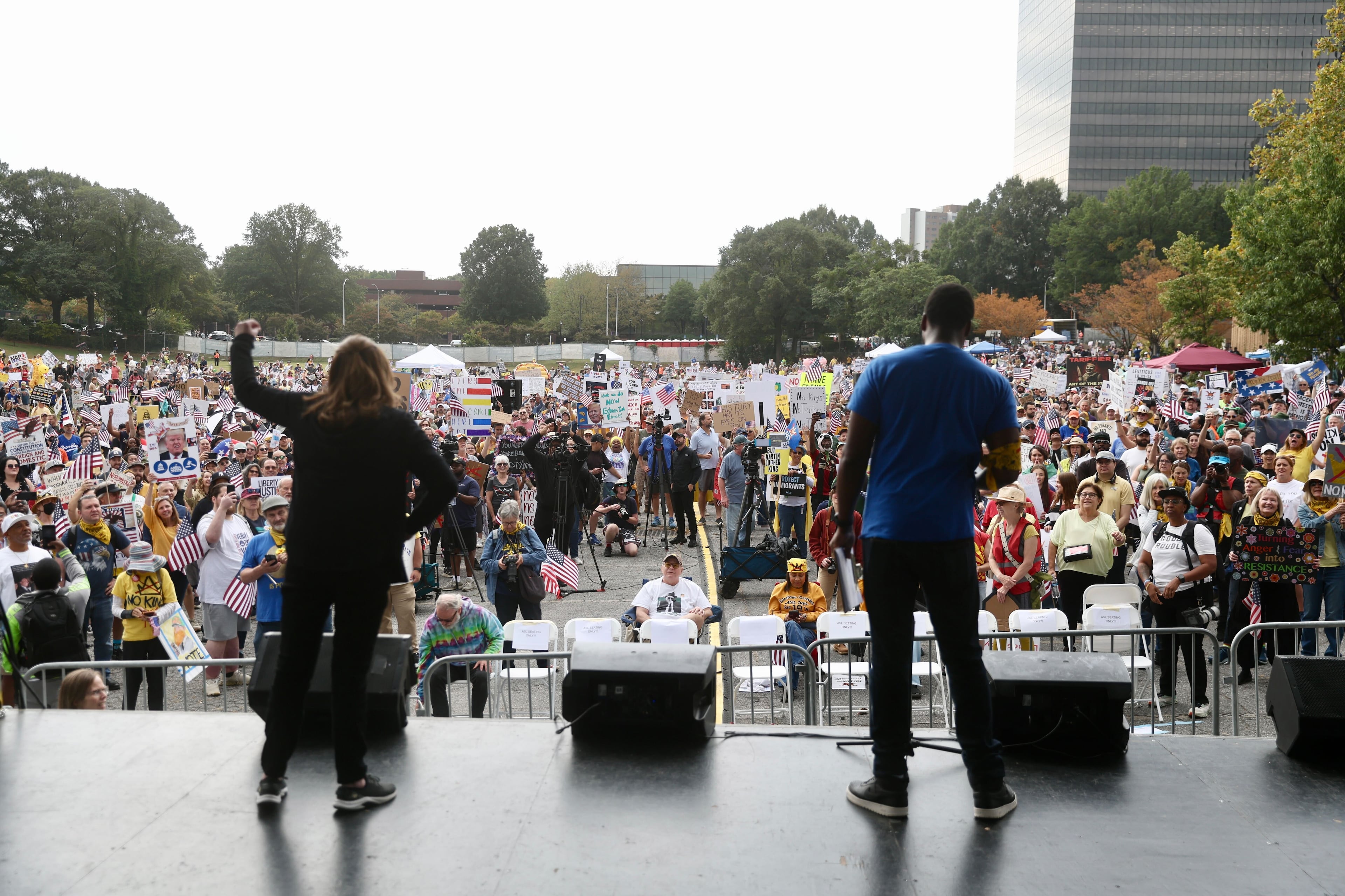 Hundreds of people gathered at the Atlanta Civic Center parking lot Saturday morning for a "No Kings" protest. (Abbey Cutrer / AJC)