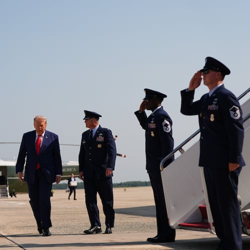 President Donald Trump, left, is escorted by Air Force Col. Christopher M. Robinson, Commander, 89th Airlift Wing, right, from Marine One to Air Force One, Wednesday, July 22, 2026, at Joint Base Andrews, Md. (AP Photo/Julia Demaree Nikhinson)