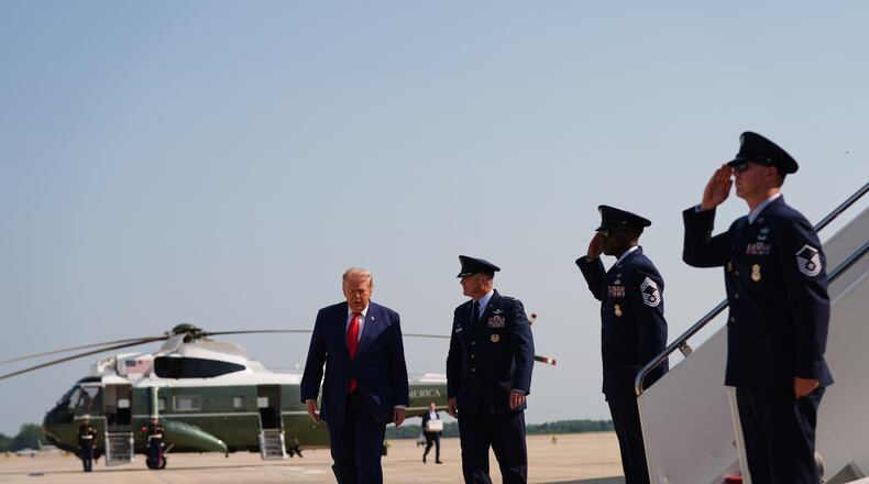 President Donald Trump, left, is escorted by Air Force Col. Christopher M. Robinson, Commander, 89th Airlift Wing, right, from Marine One to Air Force One, Wednesday, July 22, 2026, at Joint Base Andrews, Md. (AP Photo/Julia Demaree Nikhinson)