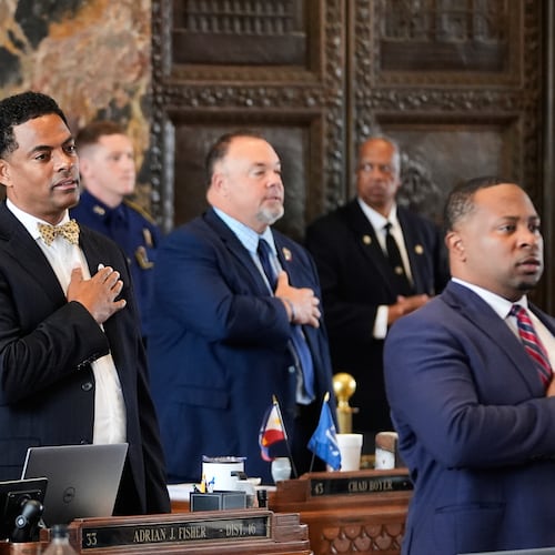 Louisiana Reps. Adrian Fisher, D-Dist 16, left, Chad Michael Boyer, R-Dist 46, and C. Travis Johnson, D-Dist 21, right, recite the pledge of allegiance prior to a house vote on a redistricting plan to eliminate a majority-Black congressional district in response to a U.S. Supreme Court ruling, in Baton Rouge, La., Thursday, May 21, 2026. (AP Photo/Gerald Herbert)