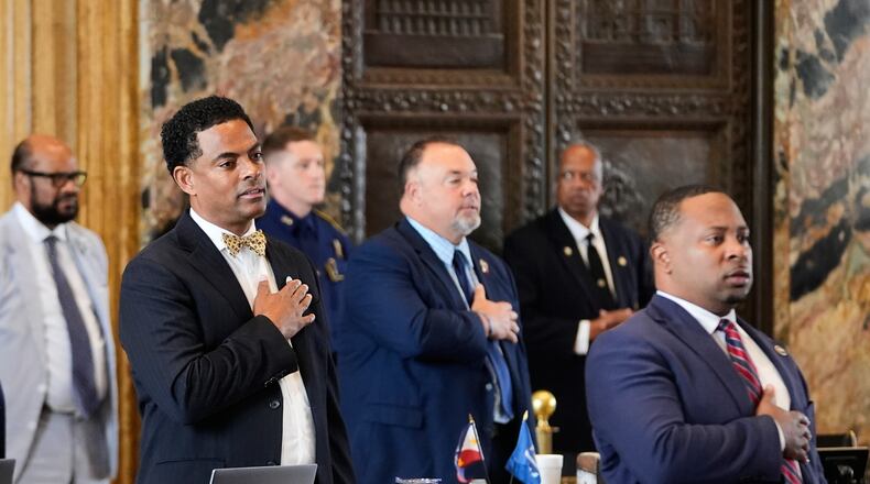 Louisiana Reps. Adrian Fisher, D-Dist 16, left, Chad Michael Boyer, R-Dist 46, and C. Travis Johnson, D-Dist 21, right, recite the pledge of allegiance prior to a house vote on a redistricting plan to eliminate a majority-Black congressional district in response to a U.S. Supreme Court ruling, in Baton Rouge, La., Thursday, May 21, 2026. (AP Photo/Gerald Herbert)