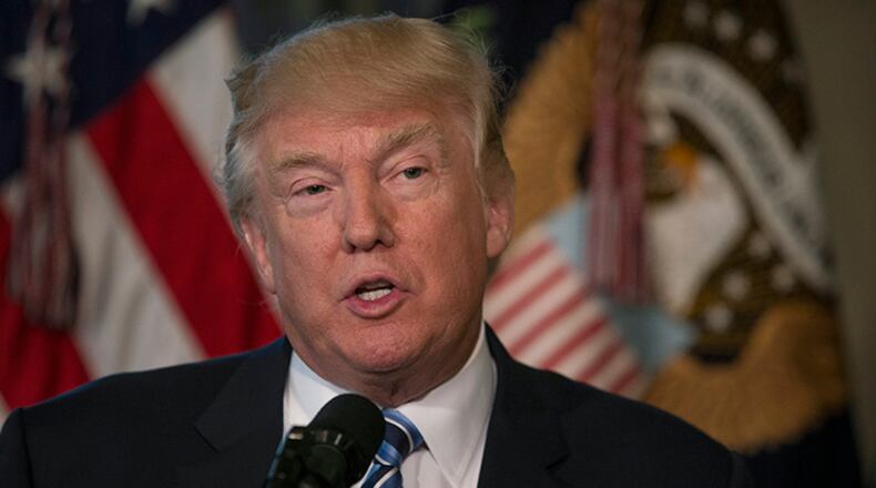 President Donald Trump visits Treasury Secretary Steven Mnuchin's office to sign new executive directives on tax regulations, in Washington, April 21, 2017. House Democrats plan to have Massachusetts Rep. Katherine M. Clark introduce legislation requiring Trump to release his tax returns from 2007 to 2016, according to The Washington Post.