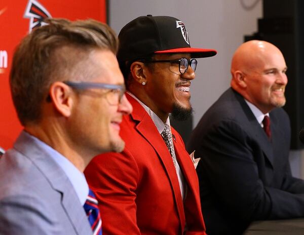 Atlanta Falcons General Manager Thomas Dimitroff, left, attends a news conference with first-round draft pick Vic Beasley, center, and head coach Dan Quinn at the Falcons training facility on Friday, May 1, 2015, in Flowery Branch, Ga. (Curtis Compton/Atlanta Journal-Constitution via AP) MARIETTA DAILY OUT; GWINNETT DAILY POST OUT; LOCAL TELEVISION OUT; WXIA-TV OUT; WGCL-TV OUT All smiles: Dimitroff, Beasley, Quinn. (Curtis Compton/AJC photo)