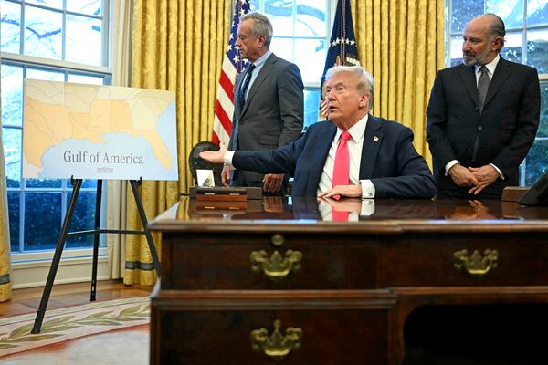 President Donald Trump gestures to a poster that says "Gulf of America" as Health and Human Services Secretary Robert F. Kennedy Jr. (left) and Commerce Secretary Howard Lutnick (right) watch at the White House earlier this year.